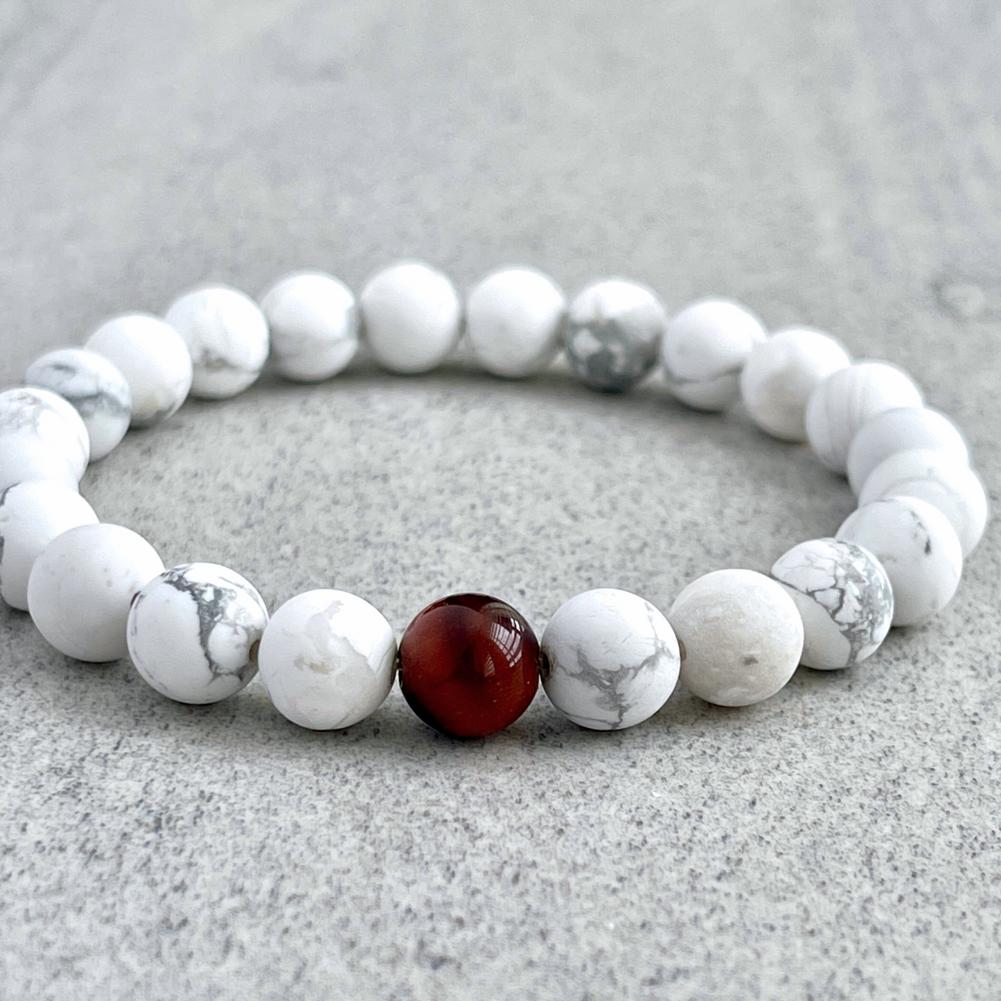 Matte White Howlite with a Single Red Tiger Eye Bracelet