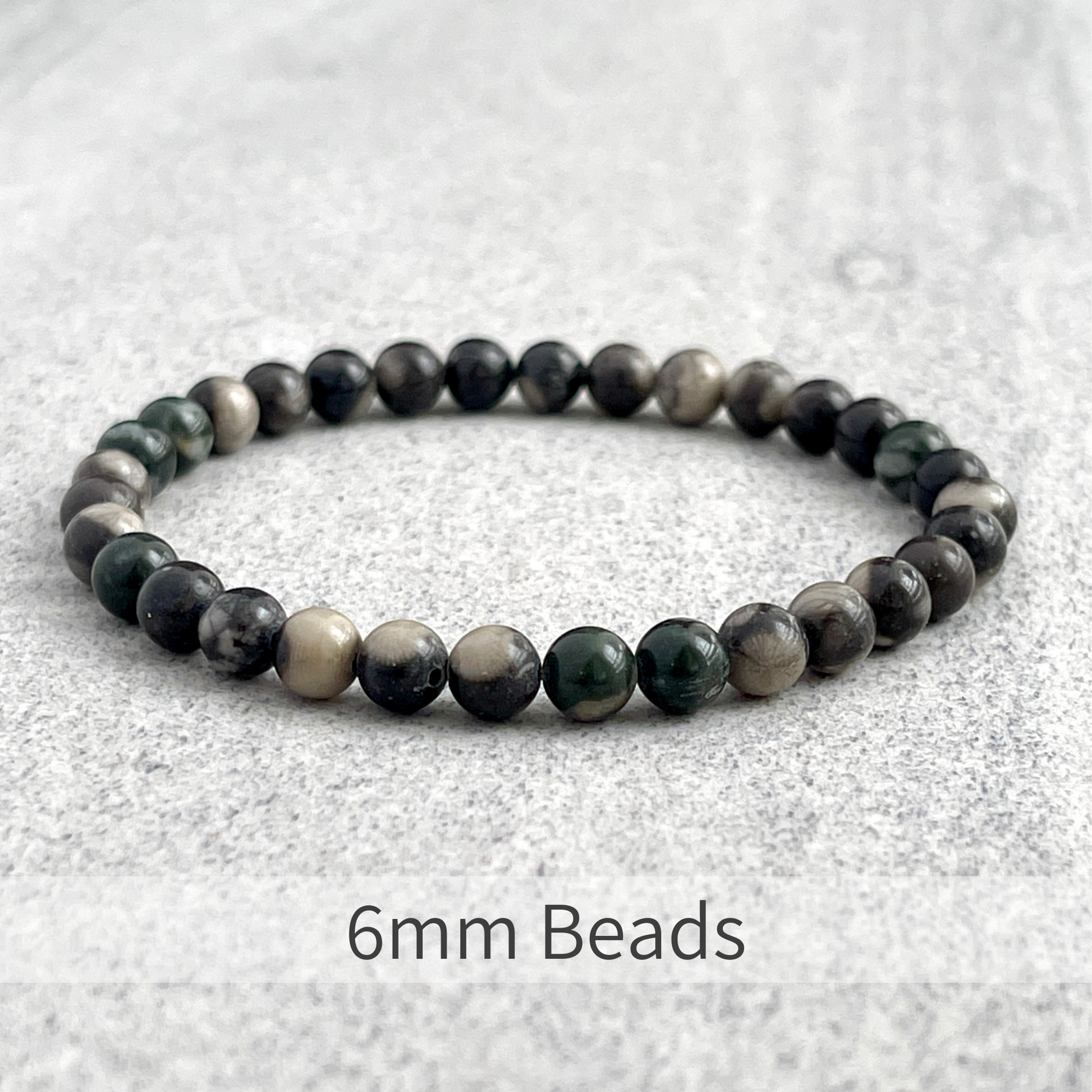 Orthoceras Fossil Jasper beaded bracelet on white background