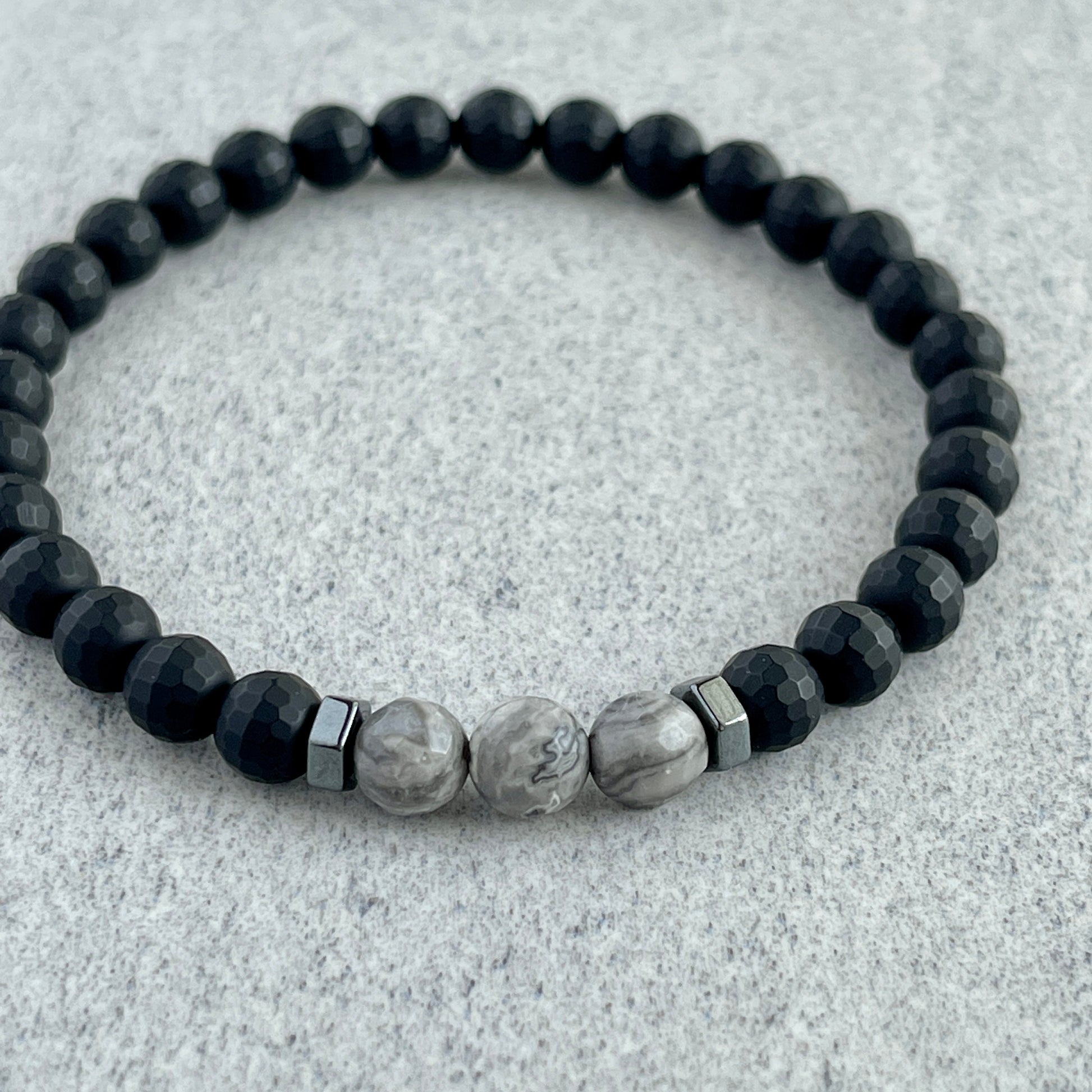 Faceted Matte Onyx bracelet displayed on marble surface