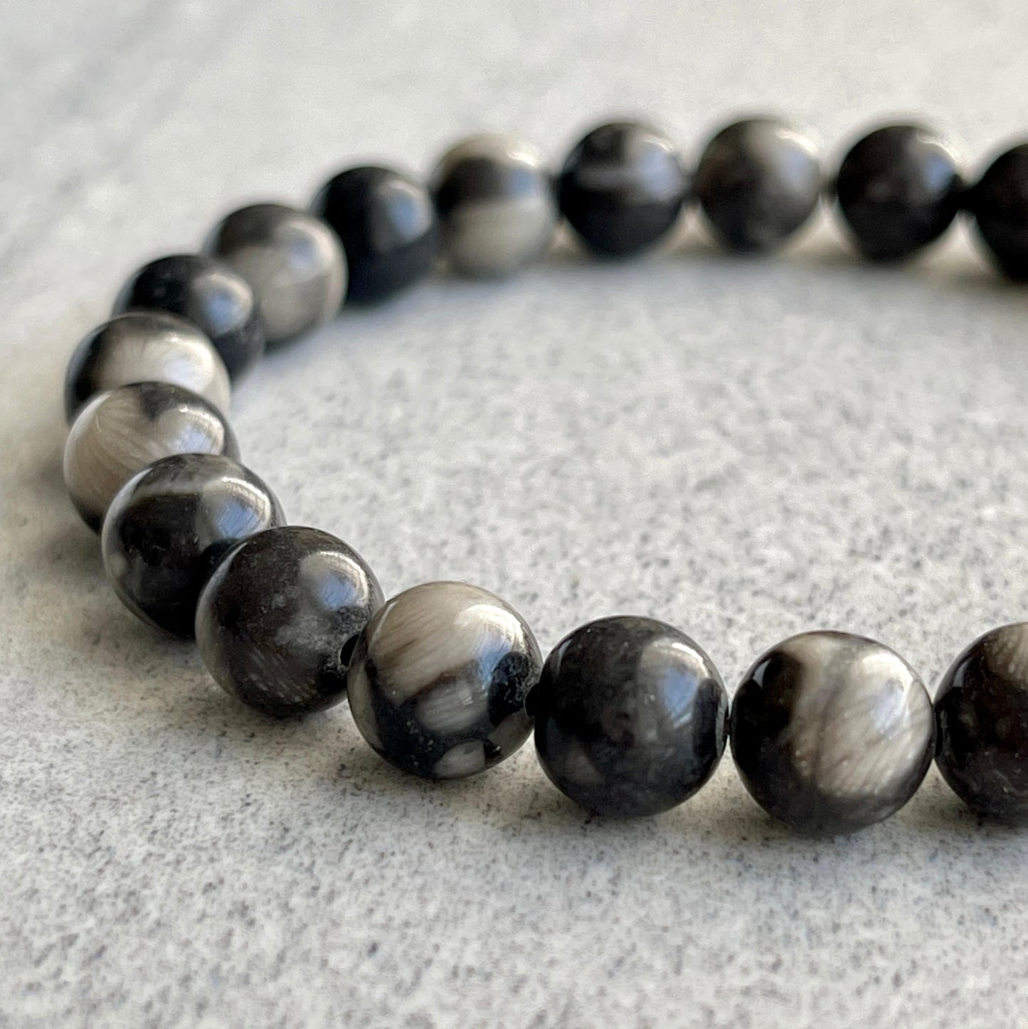 Close-up of Orthoceras Fossil Jasper beads in bracelet